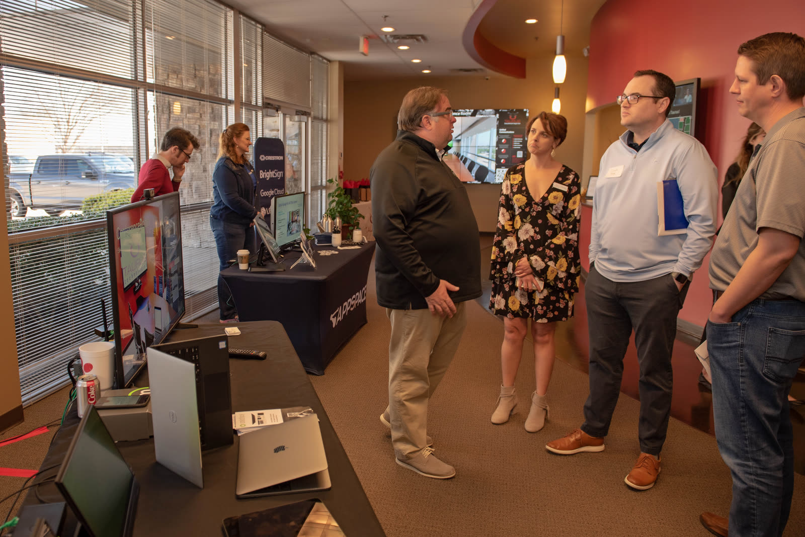 Attendees talking through a setup with a specialist between demo tables